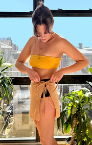 Mini tie skirt or sarong in sand color. Sizes small to extra large.